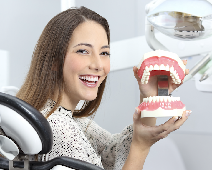 woman holding a mouth model